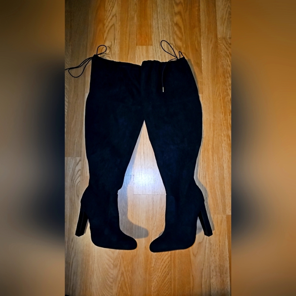 Black thigh high heeled boots